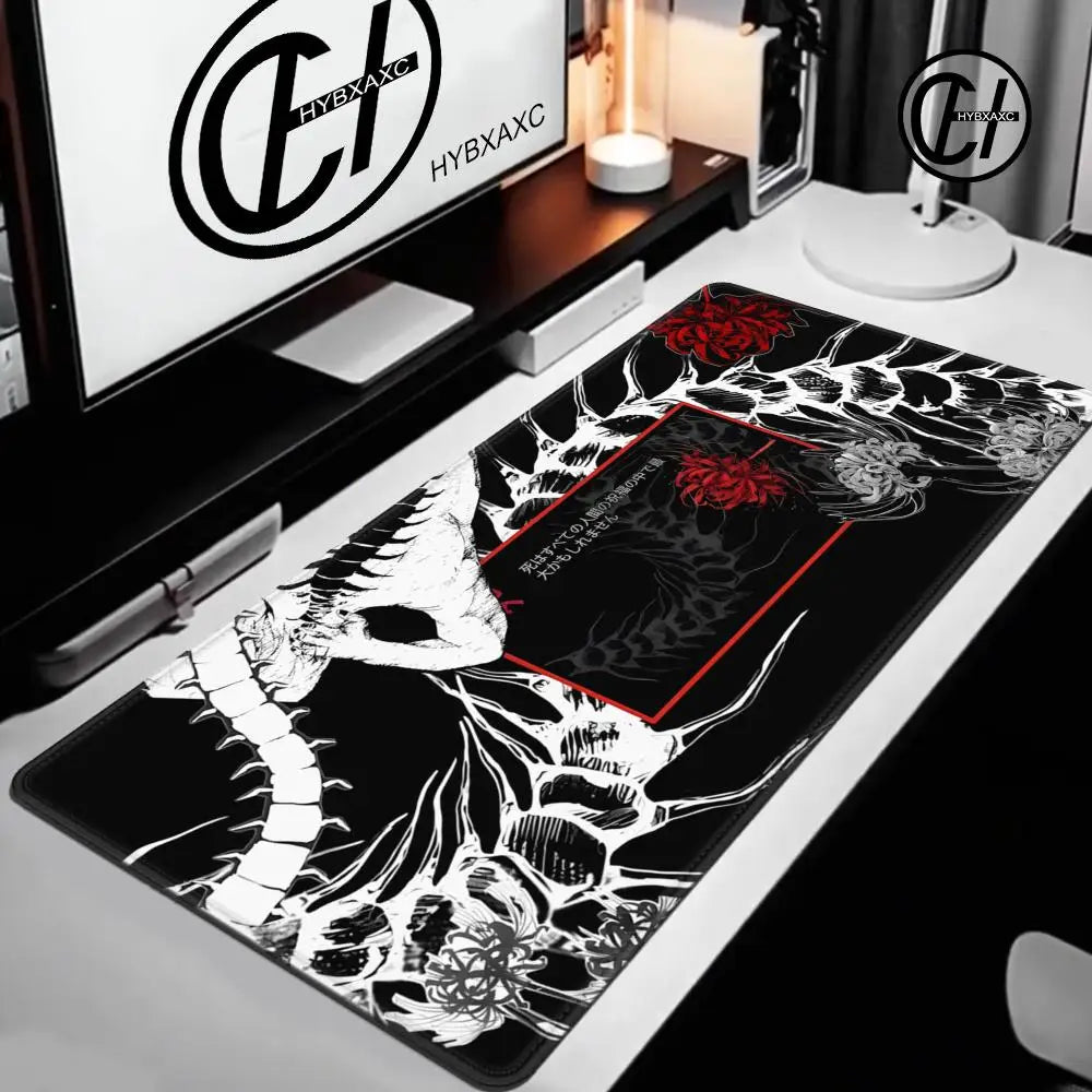Decorative mouse pad with black and white design on a desk with computer setup.