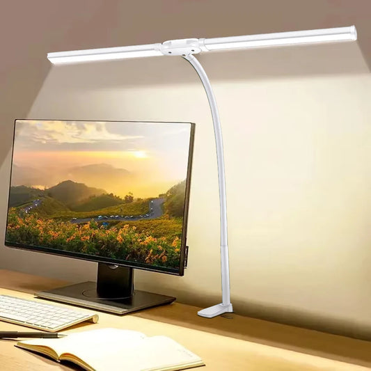 White LED desk lamp illuminating a computer monitor on a desk.